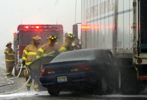 snow crash ASSIGNMENT INFO: Flint Township firemen hose down a that briefly caught fire after losing control and colliding with a semi truck Monday afternoon while travelling on I-69 Westbound near the I-75 interchange. The driver of the car suffered minor injuries. No other information was immediately available. (Date shot: 11/24/2008) (THE FLINT JOURNAL / John W. Adkisson) (Date shot: 11/24/2008) (THE FLINT JOURNAL / John W. Adkisson)